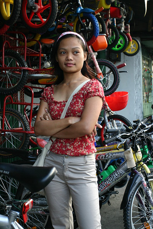 Photo of Woman Standing Outside a Bike Shop in Angeles City(6597)