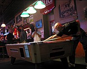 Man Playing Pool in a Bar