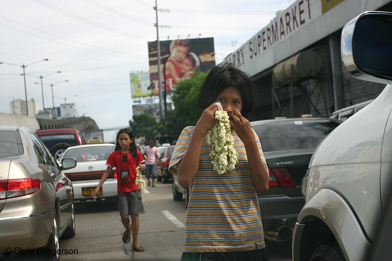 Photo of Girls Selling Flower Necklaces to Cars, Manila(4612)
