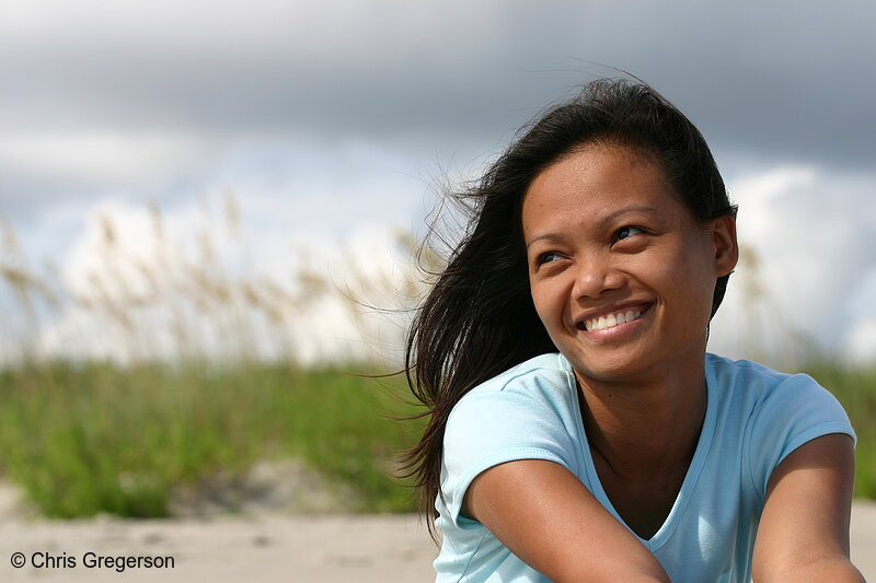 Photo of Young Asian Woman Sitting, Smiling on Beach(4945)