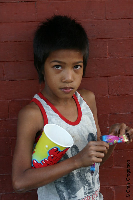 Photo of A Young Filipino Boy Eating a Candy Bar.(5228)