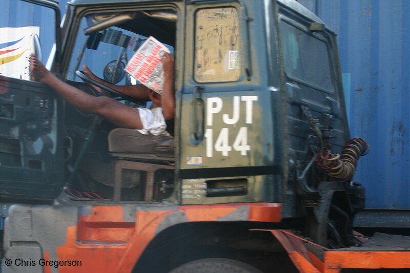 Photo of Filipino Truck Driver Reading a Newspaper in his Cab(5509)