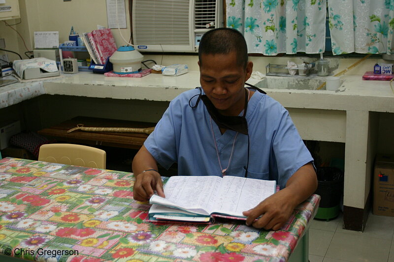 Photo of Filipino Lab Technician Reading Medical Laboratory Results(5926)