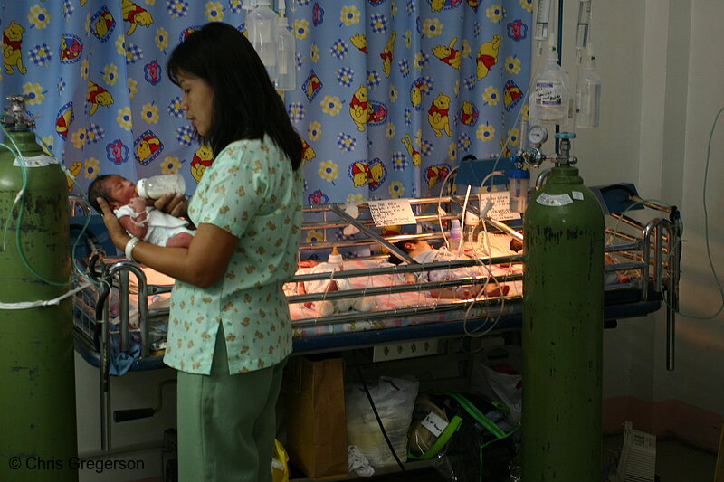 Photo of Nurse Bottle-Feeding Baby in the Nursery of Ospital ng Angeles (ONA)(5954)