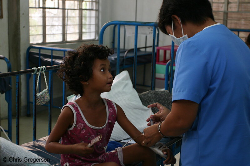 Photo of Nurse Giving Injection to Young Patient at ONA(5963)
