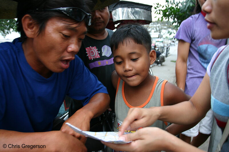 Photo of Tricyle Drivers and Local Residents Browsing a Map of Angeles City, Pampanga(5966)