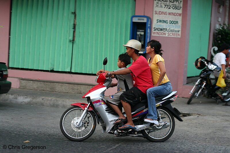 Photo of Family on a Small Motorcycle Together(6894)