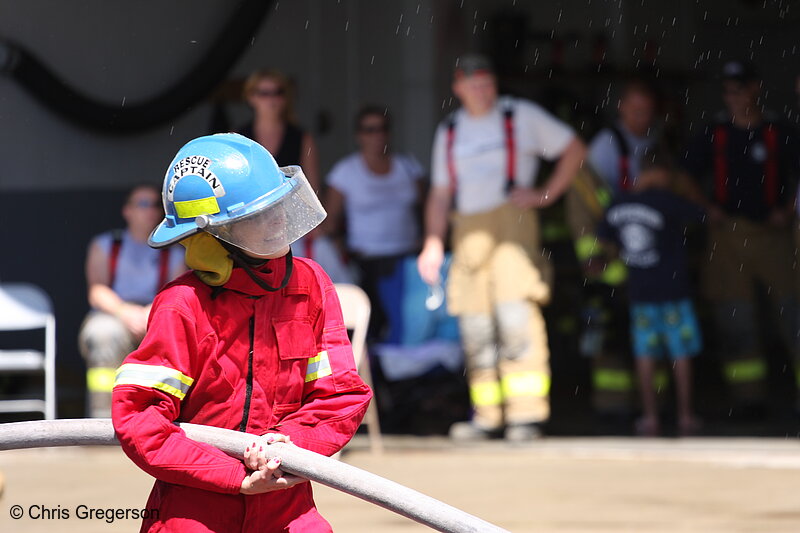Photo of Fire Fighter Holding Hose for Water Battle(7777)